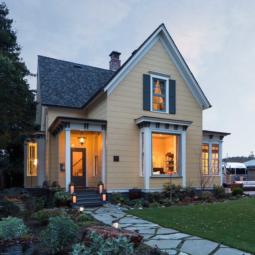 Mid-sized traditional two-storey yellow exterior in San Francisco with a gable roof.