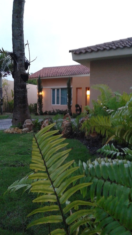 Photo of a large mediterranean front yard full sun garden for summer in Other with a garden path and brick pavers.