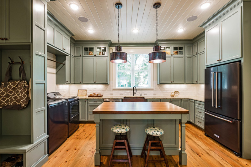Inspiration for an expansive arts and crafts u-shaped kitchen in Other with recessed-panel cabinets, green cabinets, granite benchtops, medium hardwood floors and brown floor.