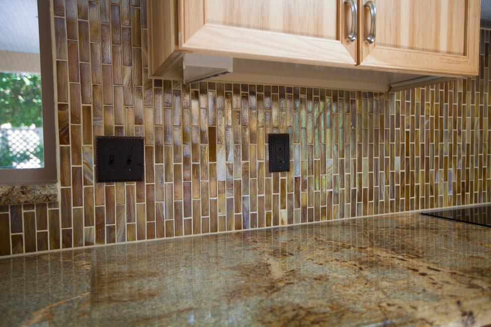 Enclosed kitchen - large transitional galley ceramic tile enclosed kitchen idea in Phoenix with an undermount sink, recessed-panel cabinets, light wood cabinets, granite countertops, brown backsplash, glass tile backsplash and stainless steel appliances
