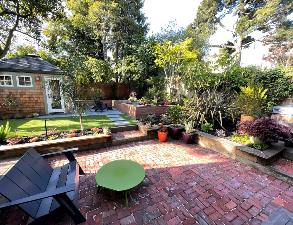 Inspiration for a small contemporary backyard partial sun garden in San Francisco with with raised garden bed and natural stone pavers.