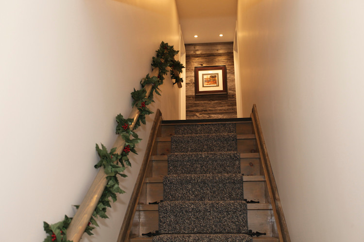 Inspiration for a mid-sized country carpeted straight staircase in Toronto with wood risers.