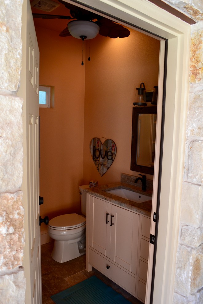 Small 3/4 bathroom in Dallas with furniture-like cabinets, white cabinets, a two-piece toilet, beige walls, travertine floors, a drop-in sink, wood benchtops and beige floor.