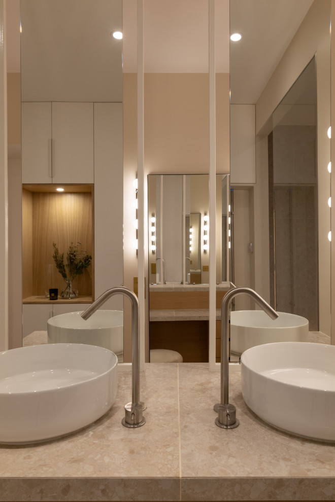 Mid-sized contemporary 3/4 bathroom in Paris with beaded inset cabinets, brown cabinets, a curbless shower, a two-piece toilet, beige tile, ceramic tile, beige walls, a drop-in sink, tile benchtops, an open shower, beige benchtops, a shower seat, a double vanity and a freestanding vanity.