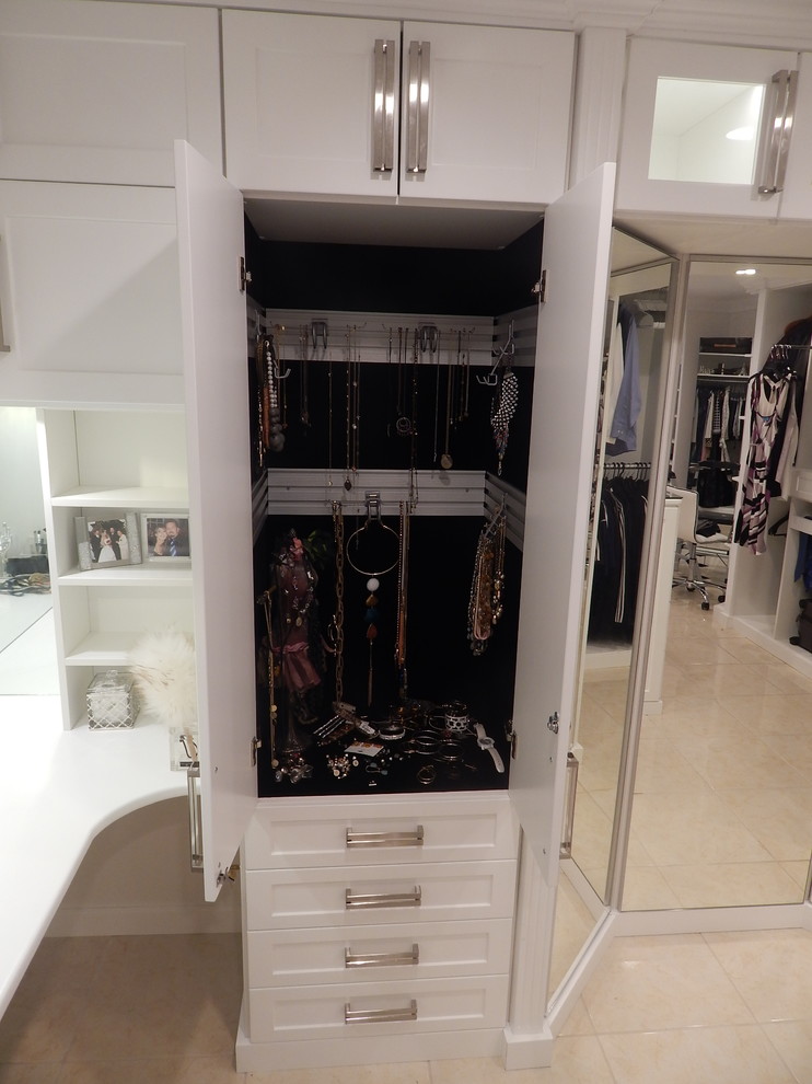 Design ideas for a large contemporary women's dressing room in Los Angeles with shaker cabinets and white cabinets.