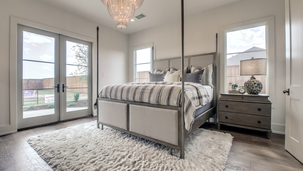 Mid-sized transitional master bedroom in Austin with white walls, medium hardwood floors, no fireplace and beige floor.