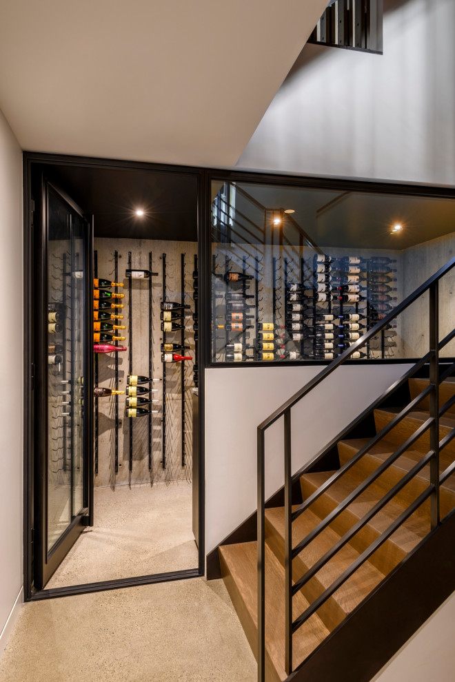 Minimalist gray floor wine cellar photo in Seattle with display racks