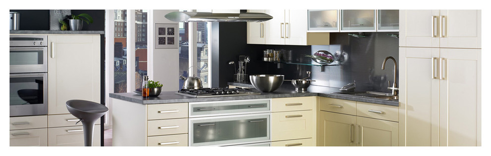 Mid-sized transitional l-shaped enclosed kitchen photo in Boston with an undermount sink, shaker cabinets, white cabinets, quartz countertops, black backsplash, metal backsplash, stainless steel appliances and no island