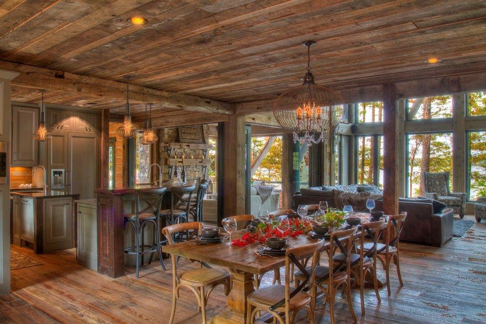 Mountain style l-shaped medium tone wood floor and wood ceiling eat-in kitchen photo in Minneapolis with an undermount sink, green cabinets, granite countertops, two islands and black countertops