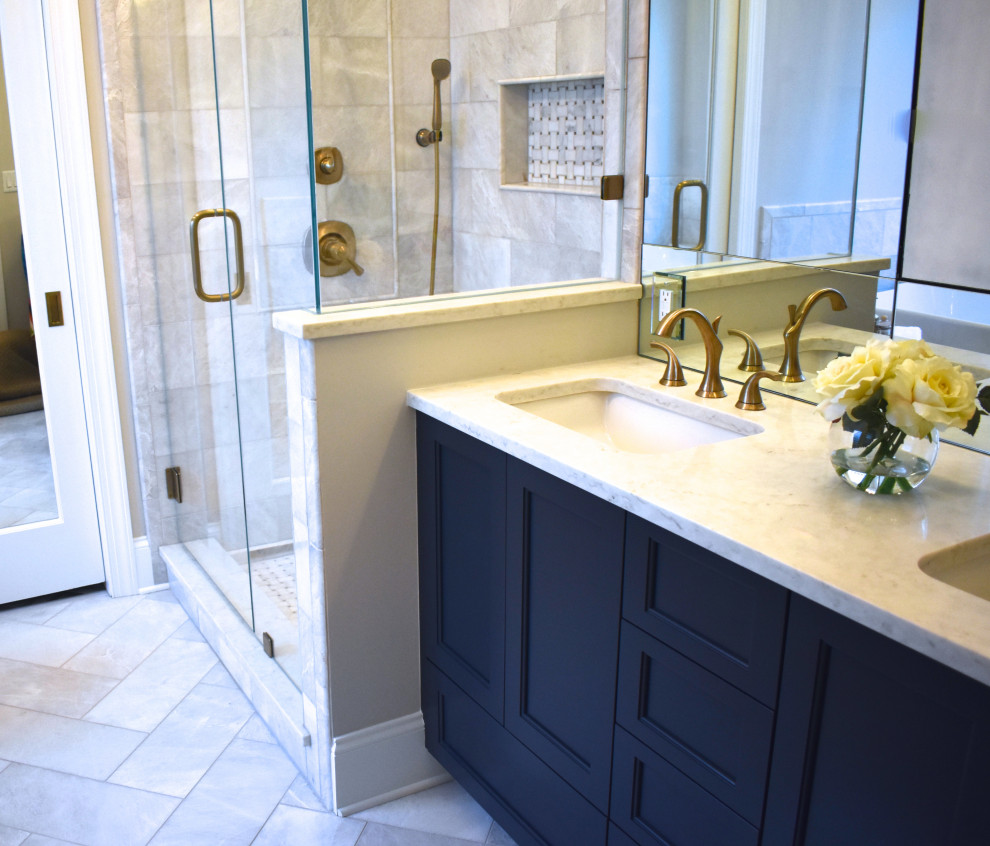 Mid-sized transitional master bathroom in Charlotte with recessed-panel cabinets, blue cabinets, a freestanding tub, an alcove shower, a two-piece toilet, gray tile, marble, grey walls, marble floors, an undermount sink, engineered quartz benchtops, white floor, a hinged shower door and grey benchtops.