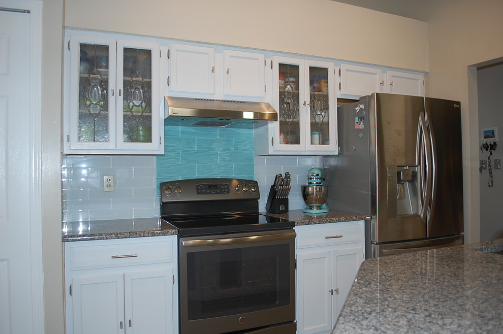 Example of a transitional u-shaped kitchen design in Jacksonville with shaker cabinets, white cabinets and granite countertops