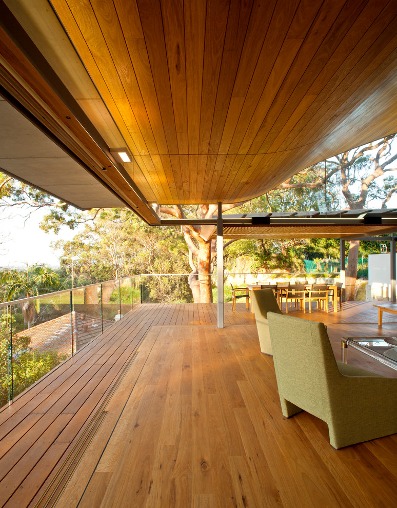 Photo of a mid-sized contemporary deck in Sydney with a roof extension.