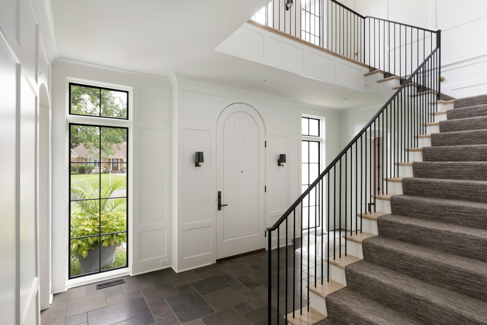 Photo of a transitional staircase in Minneapolis with panelled walls.