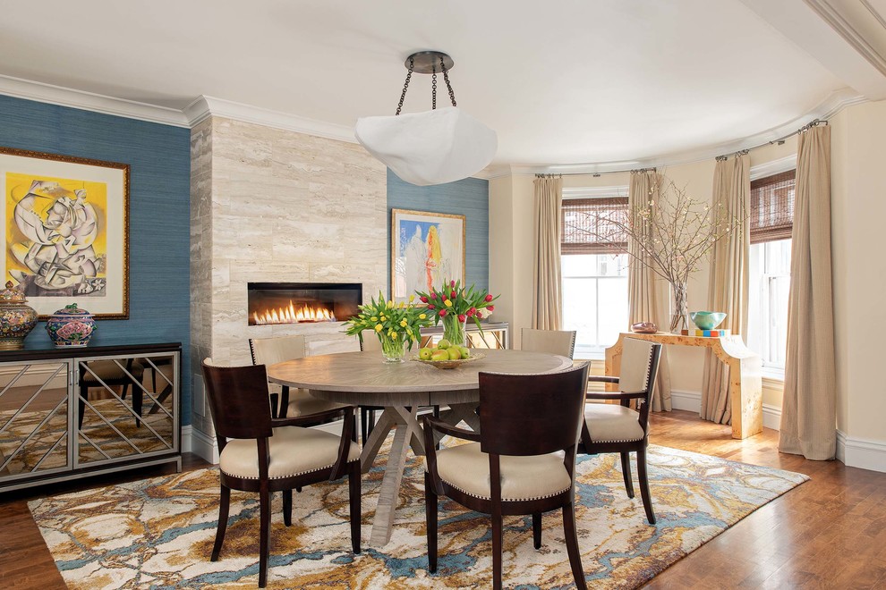 Design ideas for a mid-sized transitional open plan dining in Austin with multi-coloured walls, medium hardwood floors, a ribbon fireplace and a stone fireplace surround.