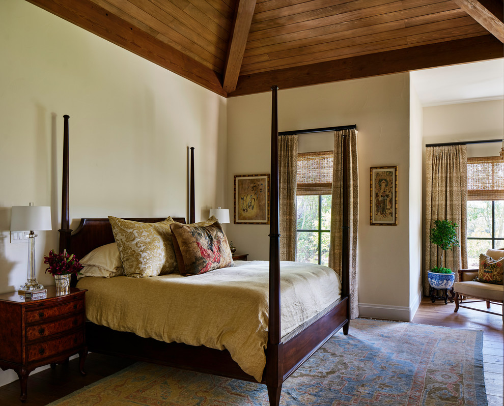 Inspiration for a mediterranean master bedroom in Other with beige walls and medium hardwood floors.