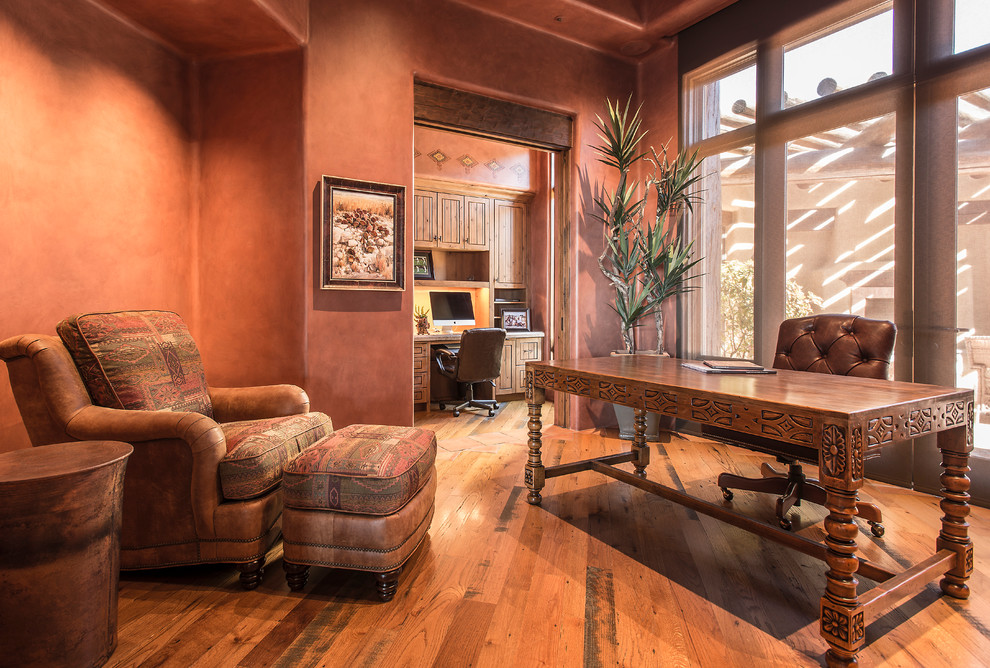 This is an example of a mid-sized study room in Phoenix with medium hardwood floors and a freestanding desk.