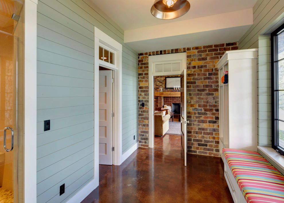 Inspiration for a mid-sized transitional brown floor and concrete floor mudroom remodel in Cedar Rapids with blue walls