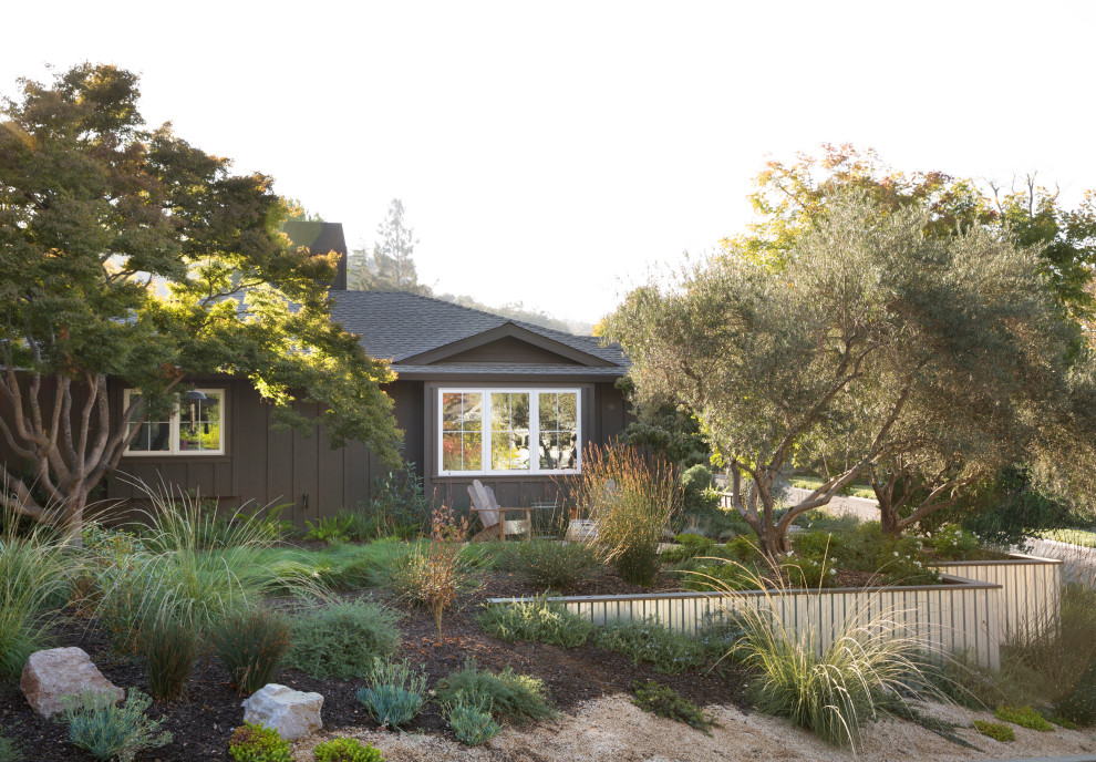 This is an example of a brown traditional bungalow detached house in San Francisco with wood cladding and board and batten cladding.