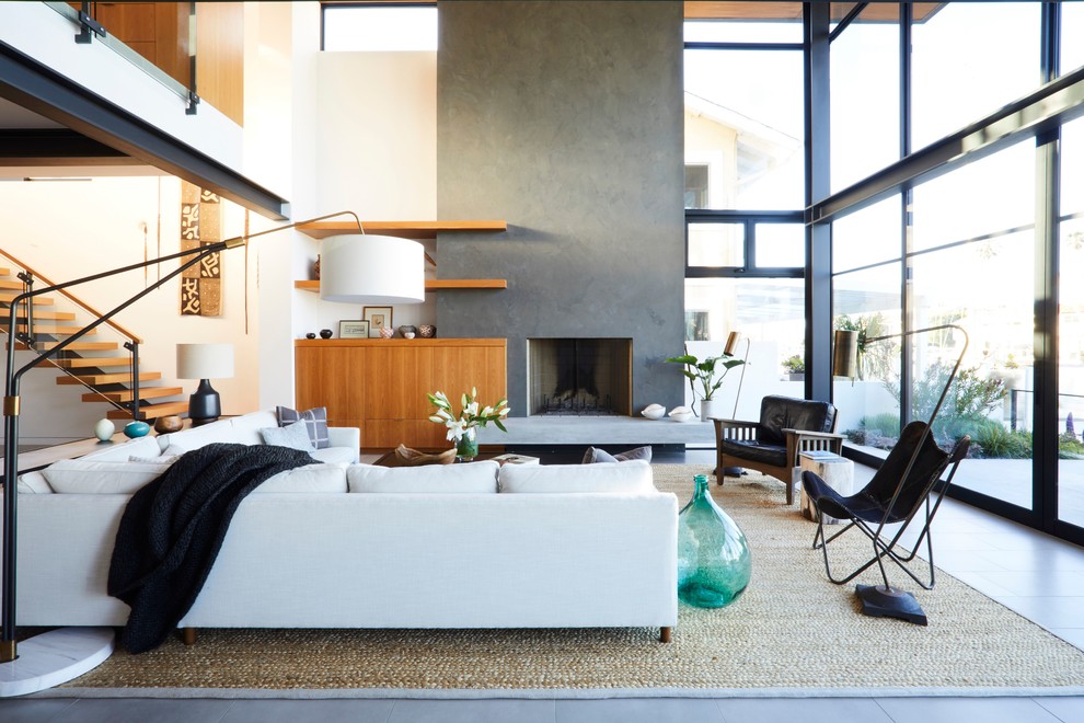 Trendy formal gray floor living room photo in Los Angeles with white walls, a standard fireplace, a concrete fireplace and no tv