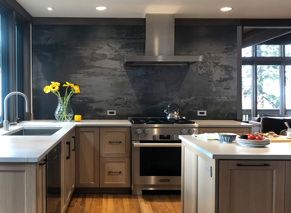 Mid-sized contemporary l-shaped eat-in kitchen in Seattle with an undermount sink, shaker cabinets, medium wood cabinets, quartz benchtops, grey splashback, stone slab splashback, stainless steel appliances, medium hardwood floors, with island, brown floor and beige benchtop.