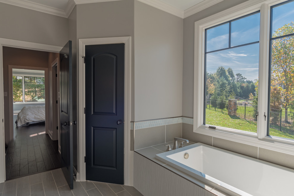 Alcove shower - mid-sized transitional master gray tile and subway tile porcelain tile alcove shower idea with shaker cabinets, white cabinets, gray walls and a vessel sink