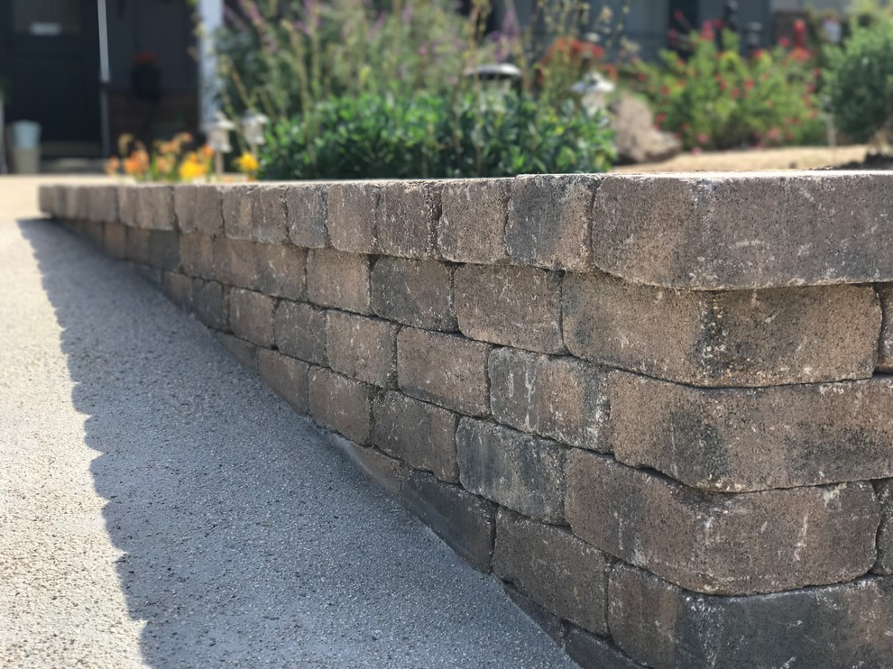 Photo of a rustic front yard concrete paver landscaping in Orange County.