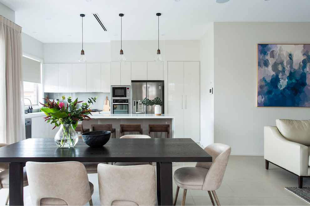 Photo of a contemporary open plan dining in Melbourne with white walls and no fireplace.