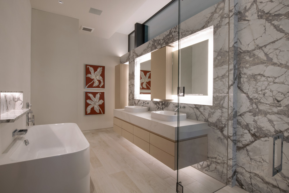 Photo of a modern bathroom in Denver with marble, marble floors and marble benchtops.