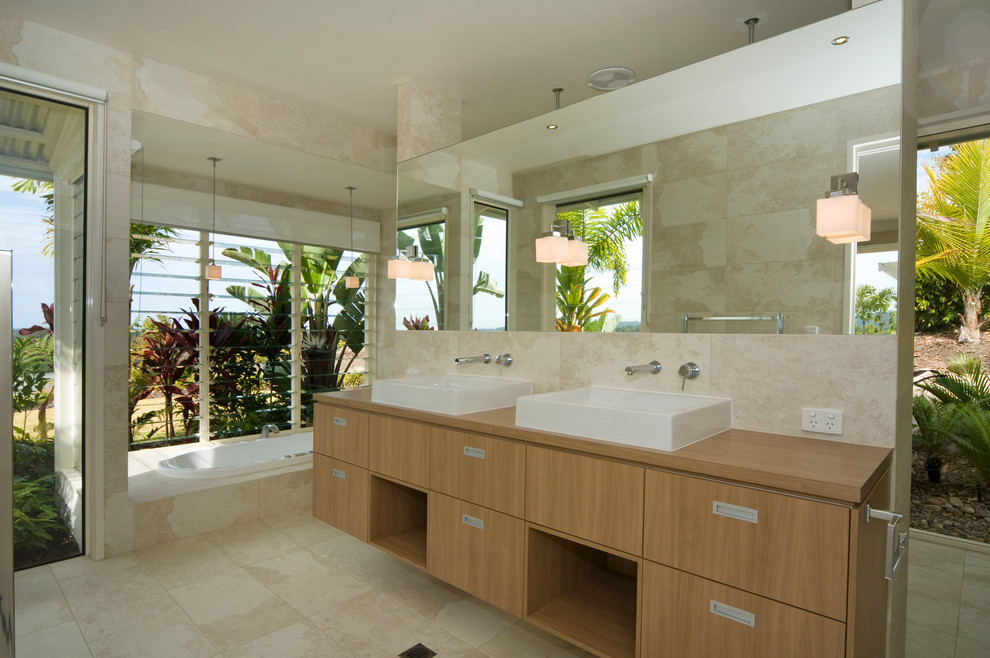 This is an example of a tropical bathroom in Brisbane with a vessel sink.