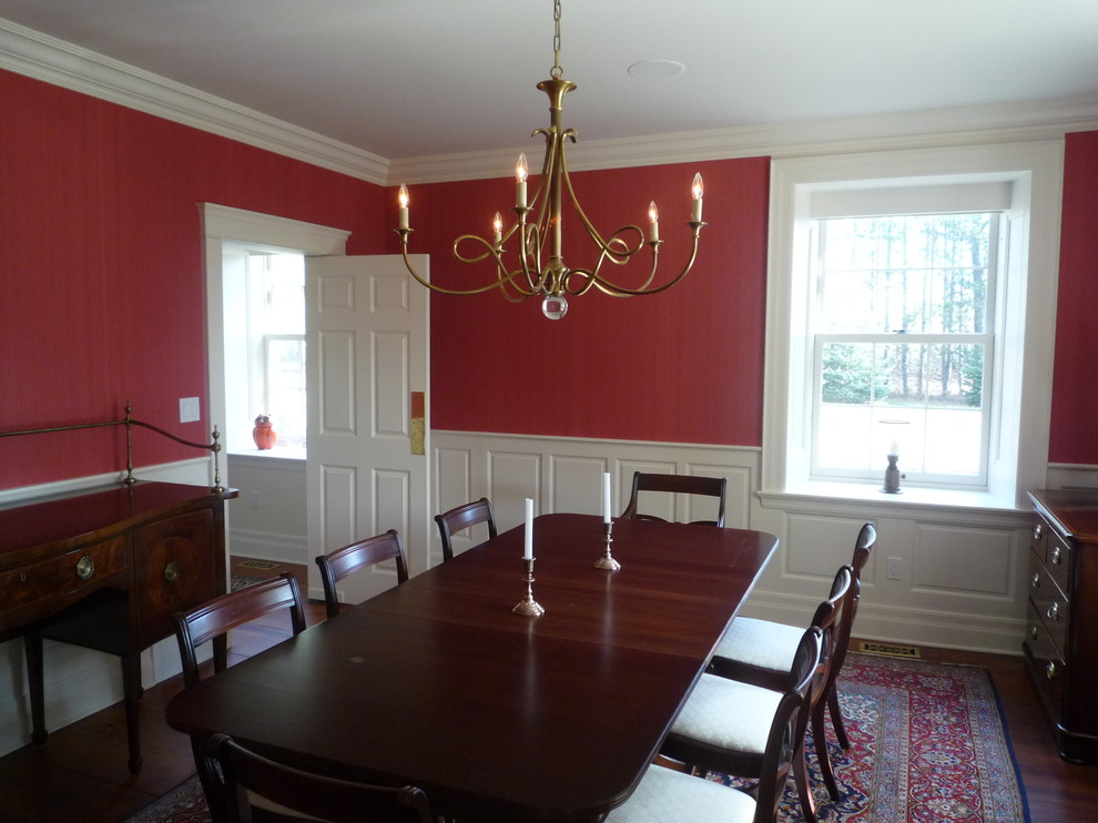 This is an example of a mid-sized traditional dining room in Toronto with red walls.