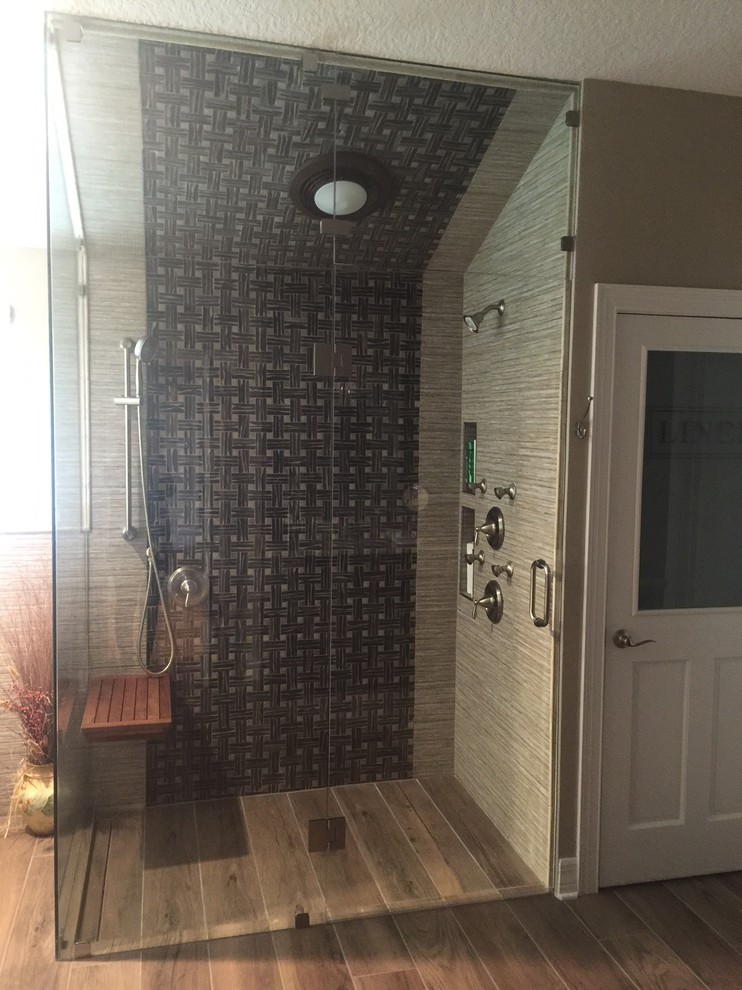 Design ideas for a mid-sized transitional master bathroom in Orlando with shaker cabinets, dark wood cabinets, a freestanding tub, a corner shower, a two-piece toilet, brown tile, porcelain tile, green walls, dark hardwood floors, an undermount sink, granite benchtops, brown floor and a hinged shower door.