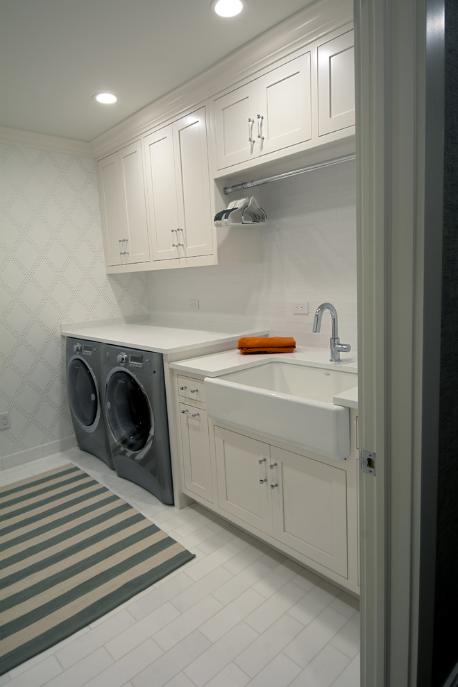 This is an example of a large contemporary laundry room in New York with medium hardwood floors and grey floor.