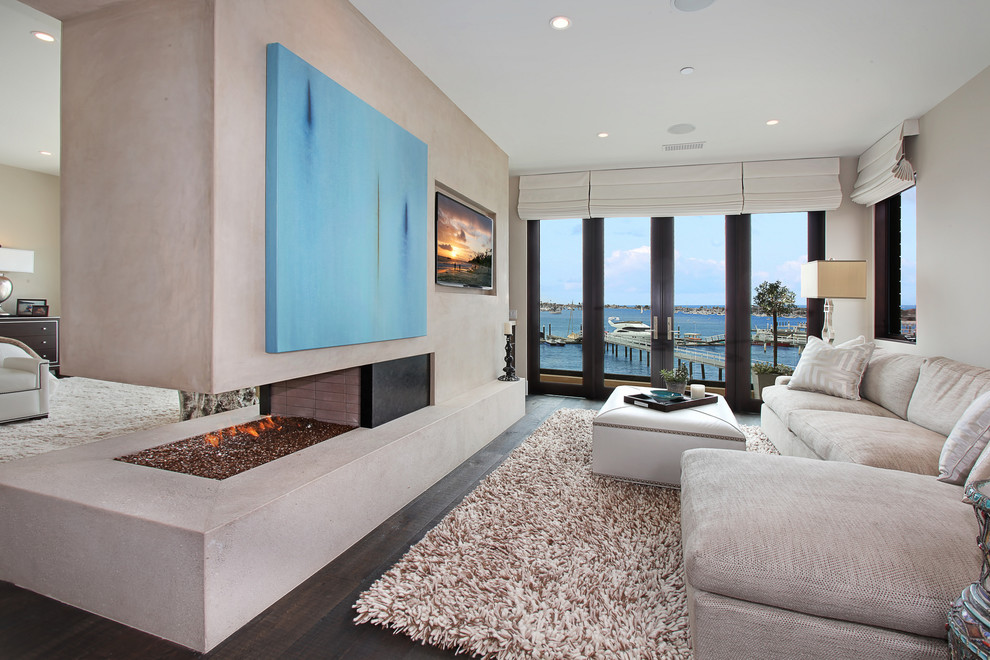 Contemporary bedroom in Orange County with a two-sided fireplace.