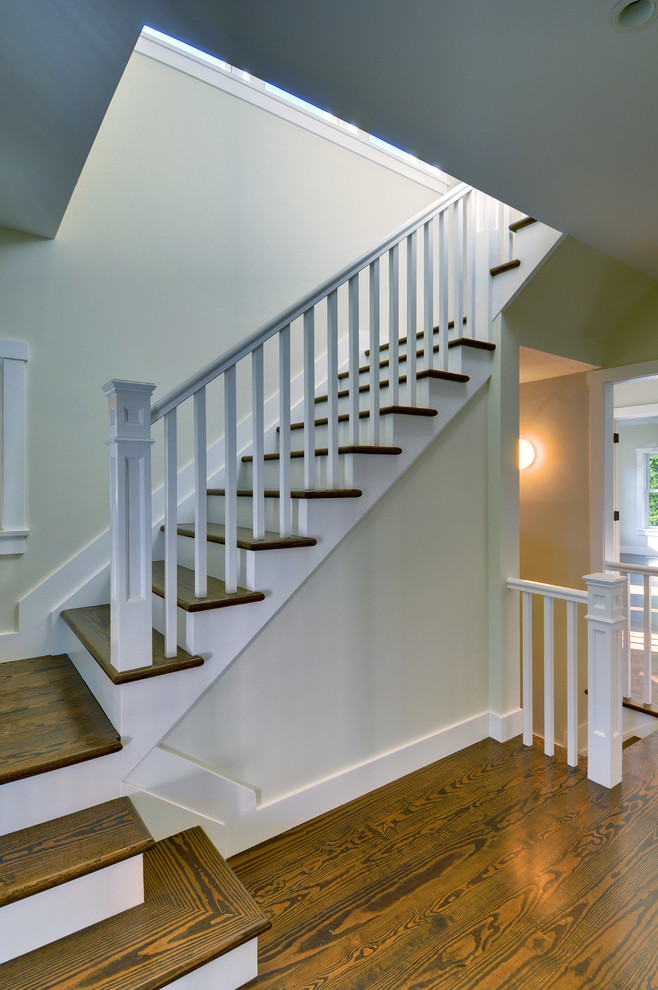 Photo of a large traditional wood l-shaped staircase in Manchester with painted wood risers.
