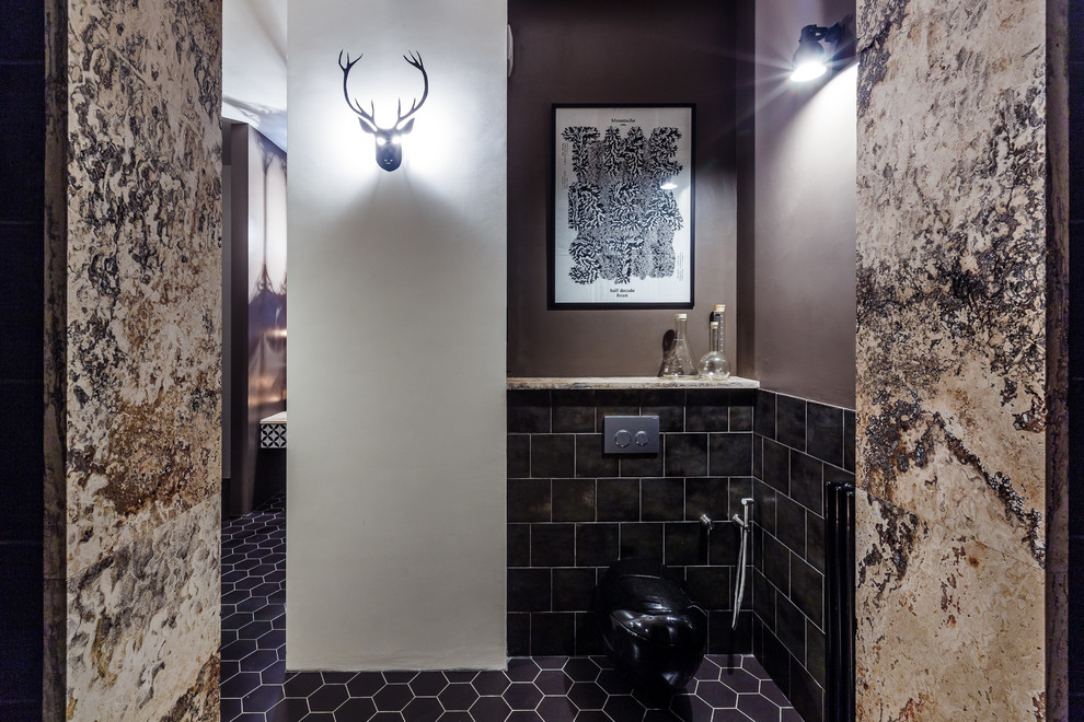 Photo of a large eclectic powder room in Other with a wall-mount toilet, black tile, ceramic tile, brown walls and ceramic floors.