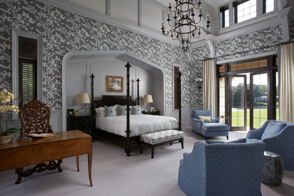 Photo of an expansive traditional master bedroom in Miami with grey walls and carpet.