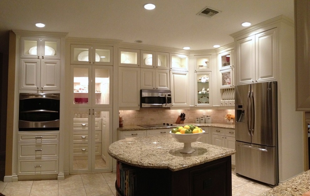 Example of a large transitional u-shaped ceramic tile and beige floor open concept kitchen design in Miami with a single-bowl sink, raised-panel cabinets, white cabinets, granite countertops, multicolored backsplash, stone tile backsplash, stainless steel appliances and an island