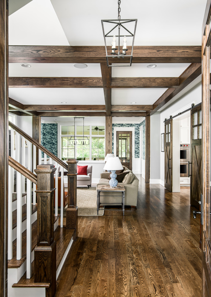 Mid-sized arts and crafts foyer in Nashville with grey walls, dark hardwood floors, a single front door, a dark wood front door and exposed beam.