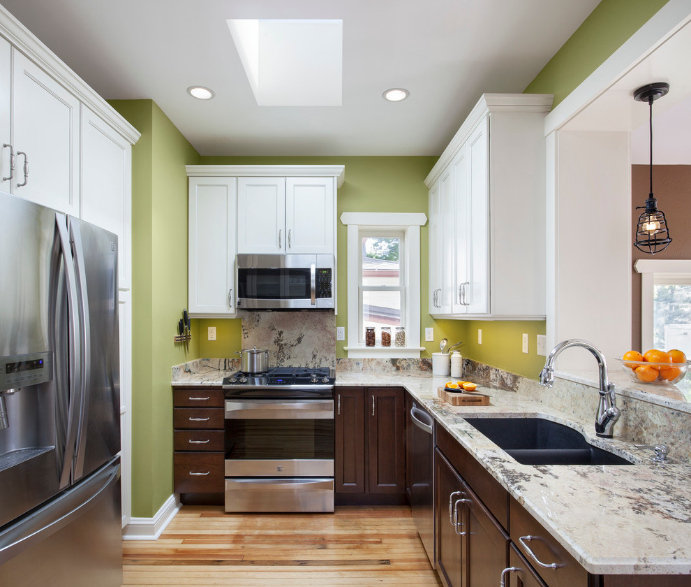 Inspiration for a transitional u-shaped kitchen in Denver with a double-bowl sink, recessed-panel cabinets, white cabinets and stainless steel appliances.