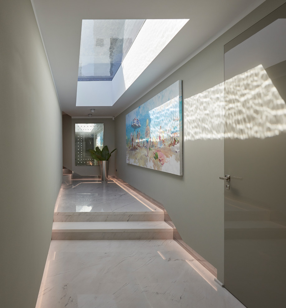 Photo of a contemporary hallway with grey walls.