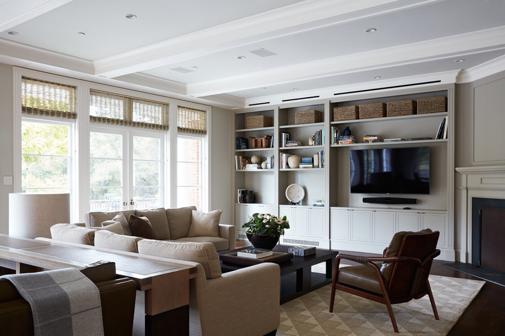 Transitional enclosed living room in San Francisco with grey walls, dark hardwood floors, a standard fireplace, a plaster fireplace surround, a wall-mounted tv, brown floor and coffered.