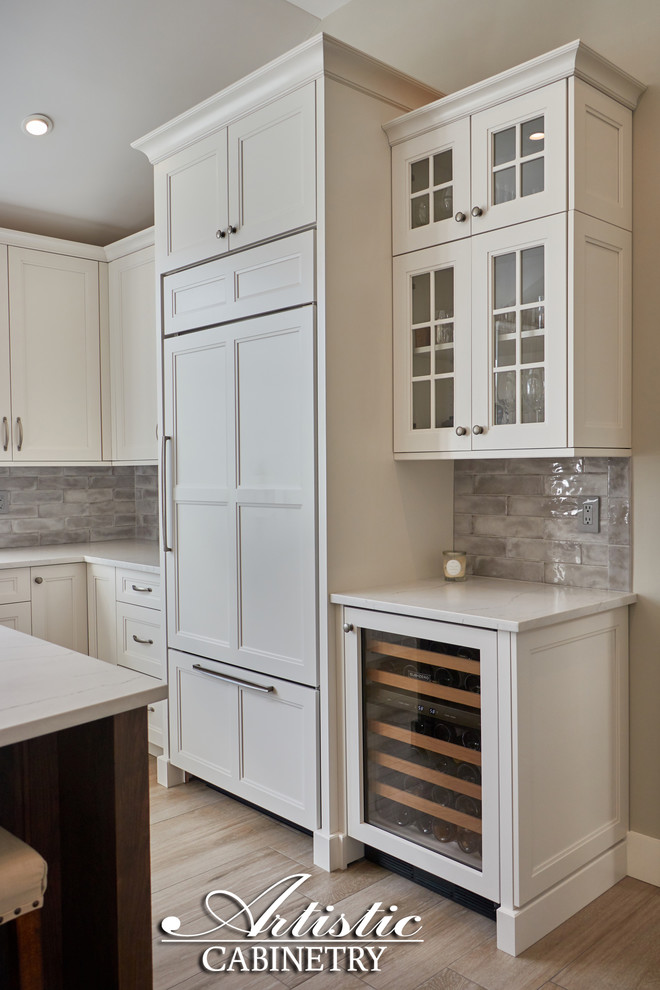 Inspiration for a mid-sized transitional u-shaped porcelain tile and beige floor open concept kitchen remodel in New York with a farmhouse sink, shaker cabinets, white cabinets, quartzite countertops, gray backsplash, porcelain backsplash, stainless steel appliances, an island and gray countertops