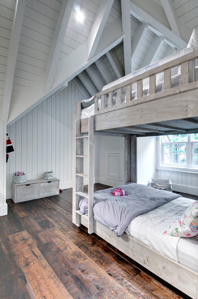 This is an example of a beach style kids' room for girls in Toronto with white walls and dark hardwood floors.