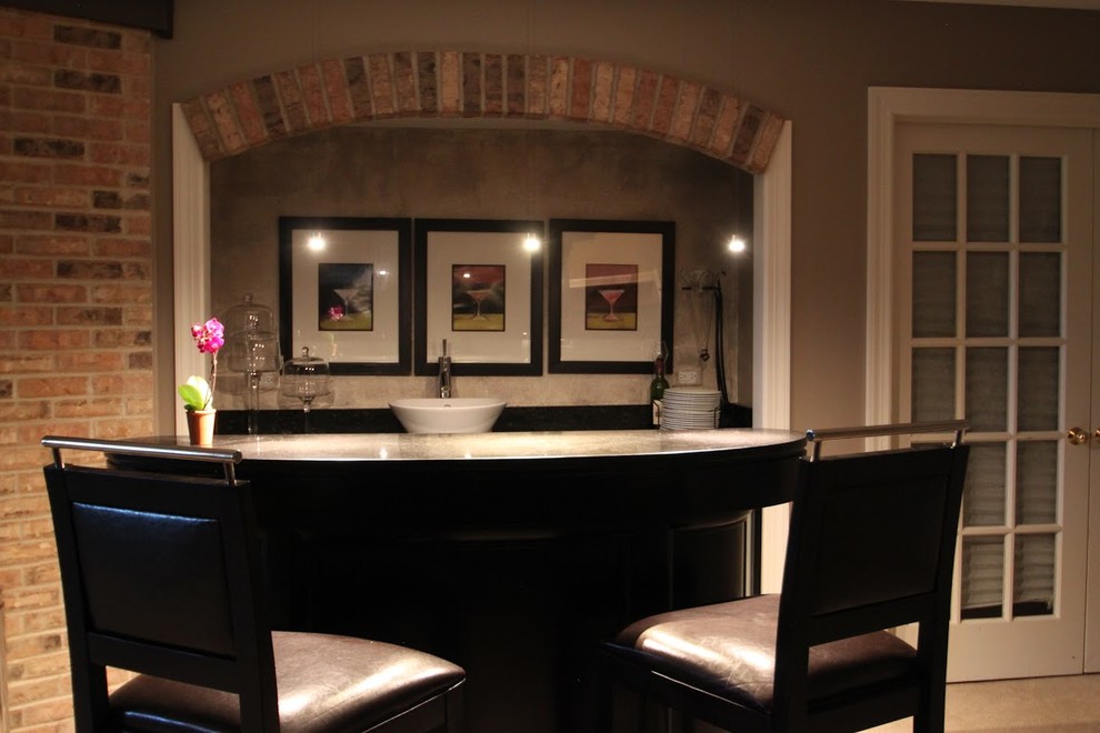 Inspiration for a mid-sized traditional single-wall seated home bar in Chicago with carpet, a drop-in sink, glass benchtops and beige floor.