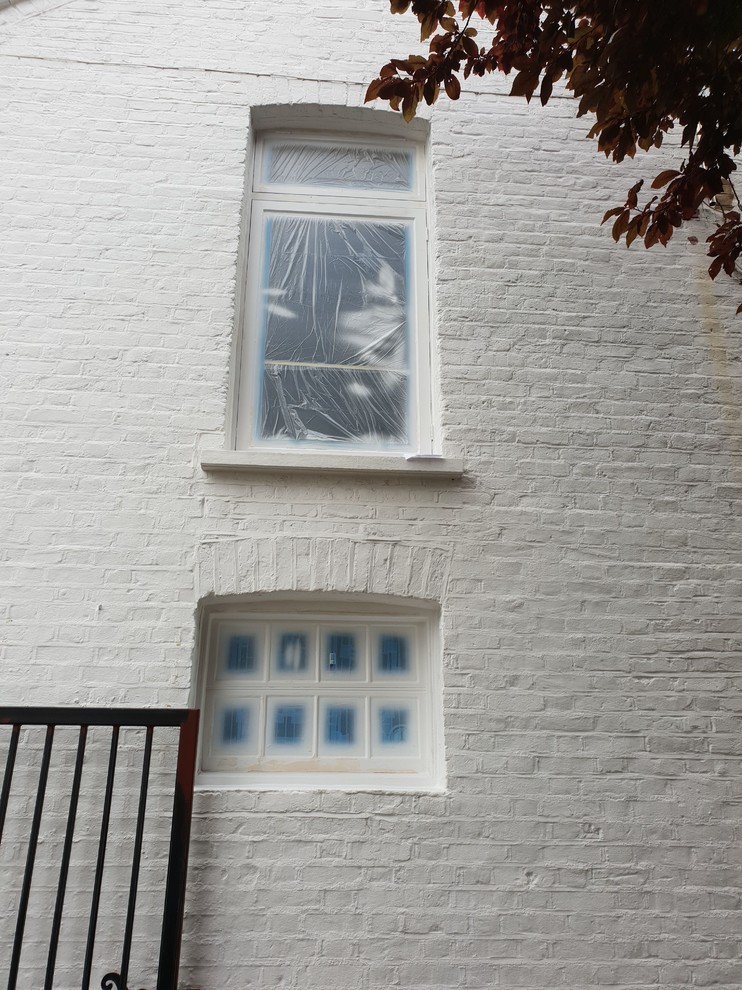 Geräumige, Einstöckige Klassische Doppelhaushälfte mit gestrichenen Ziegeln, weißer Fassadenfarbe, Satteldach, Ziegeldach und grauem Dach in London