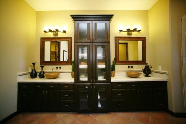 Inspiration for a mid-sized traditional master bathroom in Salt Lake City with recessed-panel cabinets, dark wood cabinets, beige walls, terra-cotta floors, a vessel sink and beige floor.