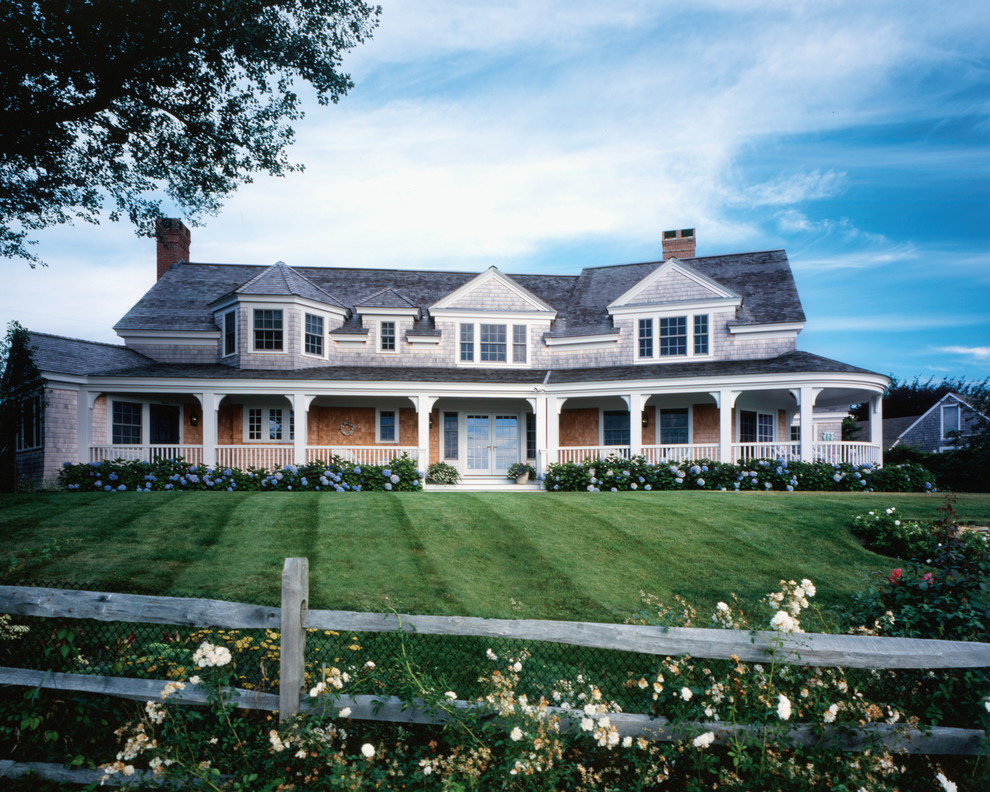 Inspiration for a mid-sized traditional two-storey grey exterior in Boston with wood siding.