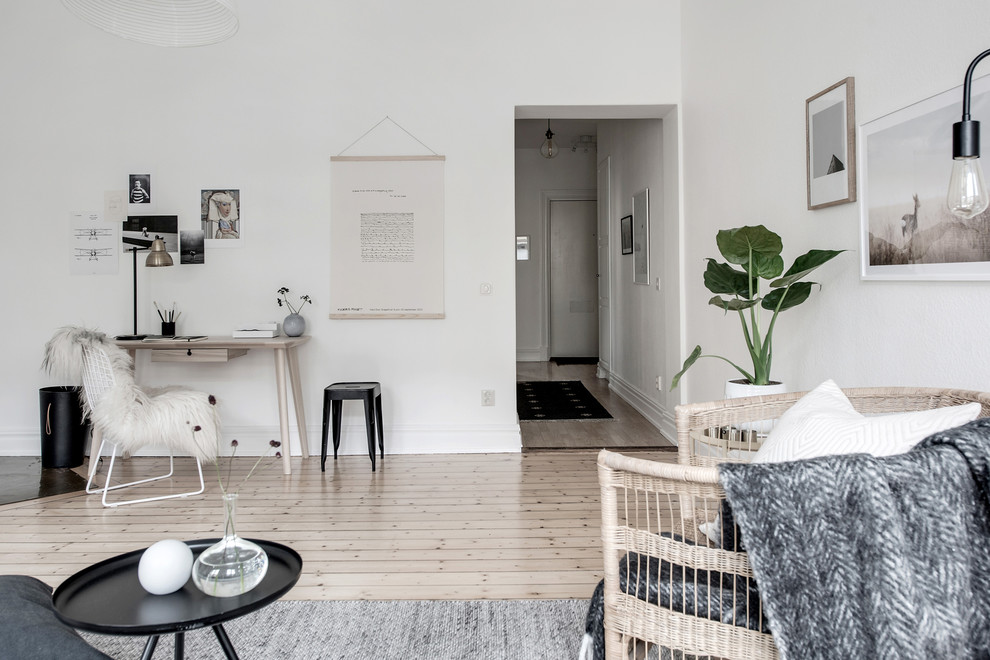 Inspiration for a mid-sized contemporary enclosed family room in Gothenburg with white walls and beige floor.