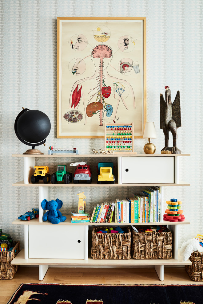 Photo of a mid-sized contemporary gender-neutral kids' playroom for kids 4-10 years old in New York with beige walls, light hardwood floors and brown floor.