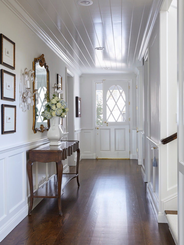 Inspiration for a traditional entry hall in Orange County with white walls, dark hardwood floors, a dutch front door and a white front door.